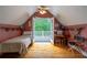 Bedroom with vaulted ceilings, dormer windows, access to a balcony and hardwood floors at 625 W Lake Dr, Oxford, GA 30054