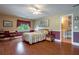 Comfortable bedroom features wood floors, painted walls, ceiling fan, and access to a bathroom at 625 W Lake Dr, Oxford, GA 30054