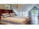 Comfortable bedroom with blue accents, natural light, sloped ceilings and hardwood floors at 625 W Lake Dr, Oxford, GA 30054
