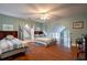 Spacious bedroom with two beds, hardwood floors, blue walls, and an adjoining room with stairs at 625 W Lake Dr, Oxford, GA 30054