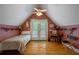 Bedroom with vaulted ceilings, dormer windows, access to a balcony and hardwood floors at 625 W Lake Dr, Oxford, GA 30054