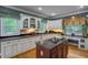Well-lit kitchen with granite countertops, an island cooktop, and ample cabinet space at 625 W Lake Dr, Oxford, GA 30054