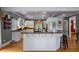 Spacious kitchen with granite countertops, white cabinets, and a large breakfast bar at 625 W Lake Dr, Oxford, GA 30054