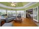Bright sunroom boasts hardwood floors, large windows, and access to the kitchen at 625 W Lake Dr, Oxford, GA 30054