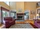 Spacious living room with water views, hardwood floors, and a stone fireplace at 625 W Lake Dr, Oxford, GA 30054