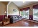 Cozy living room with natural light, vaulted ceilings, charming sofa, and hardwood floors at 625 W Lake Dr, Oxford, GA 30054