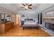 Spacious main bedroom with tray ceiling, fireplace, and hardwood floors at 625 W Lake Dr, Oxford, GA 30054