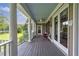 Covered porch with decorative columns and a view of the surrounding landscape and lake at 625 W Lake Dr, Oxford, GA 30054