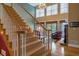 Bright, open staircase leading to a living area with water views and fireplace at 625 W Lake Dr, Oxford, GA 30054
