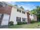 A tidy row of townhouses with white exteriors, brick accents, and well-maintained lawns and windows at 6354 Shannon Pkwy # 30C, Union City, GA 30291