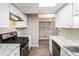 Updated kitchen features white cabinets, granite countertops, and stainless steel appliances at 6354 Shannon Pkwy # 30C, Union City, GA 30291
