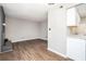 View of the living room with hardwood floors and gray painted fireplace at 6354 Shannon Pkwy # 30C, Union City, GA 30291