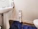 Cozy half bathroom features a pedestal sink and charming decor at 6408 Kennonbriar Ct, Lithonia, GA 30058