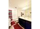 Bathroom features a large mirror, modern vanity and sink, and a shower with a stylish curtain at 6408 Kennonbriar Ct, Lithonia, GA 30058