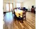 Open dining room showcases wood floors, natural light, and comfortable seating at 6408 Kennonbriar Ct, Lithonia, GA 30058