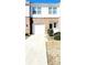 Two-story townhome with white siding, brick accents, an attached garage, and well-maintained landscaping at 6408 Kennonbriar Ct, Lithonia, GA 30058