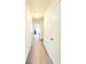 A bright hallway leads to a bedroom and features neutral carpet and fresh white walls at 6408 Kennonbriar Ct, Lithonia, GA 30058