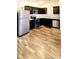 Beautiful kitchen with stainless steel appliances, ample cabinet space, and wood-look flooring at 6408 Kennonbriar Ct, Lithonia, GA 30058