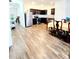Open-concept kitchen dining area with modern appliances and wood-look flooring at 6408 Kennonbriar Ct, Lithonia, GA 30058