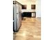 Well-lit kitchen with stainless steel appliances, dark cabinetry, and wood-look flooring at 6408 Kennonbriar Ct, Lithonia, GA 30058