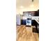 Modern kitchen with stainless steel appliances, dark cabinetry, and wood-look flooring at 6408 Kennonbriar Ct, Lithonia, GA 30058
