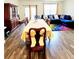 Open dining and living area, featuring hardwood floors and comfortable seating at 6408 Kennonbriar Ct, Lithonia, GA 30058