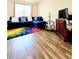 Comfortable living room featuring wood floors and a blue sectional sofa at 6408 Kennonbriar Ct, Lithonia, GA 30058