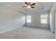 Spacious bedroom features neutral walls, plush carpet, and a modern ceiling fan at 8210 Tiger Way, Riverdale, GA 30296