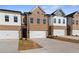 Well-maintained townhomes with brick and siding exteriors, each featuring an individual garage at 8210 Tiger Way, Riverdale, GA 30296