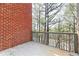 Balcony with weathered decking and railing offers views of the wooded lot and mature trees at 1292 Creekside Se Ter, Smyrna, GA 30082