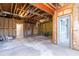 Unfinished basement with exposed ceiling, concrete floor and glass door to the outside at 1292 Creekside Se Ter, Smyrna, GA 30082