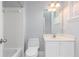 Bright bathroom showcasing shower with white tile, modern toilet, and sink with cabinet at 1292 Creekside Se Ter, Smyrna, GA 30082