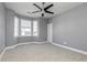 Spacious bedroom with large windows for natural light, neutral carpet, and contemporary ceiling fan at 1292 Creekside Se Ter, Smyrna, GA 30082