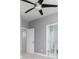 Bright bedroom with ensuite bathroom featuring neutral carpet and contemporary ceiling fan at 1292 Creekside Se Ter, Smyrna, GA 30082