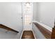Hallway with hardwood floors leads to a bright, glass-paneled door, with modern gray walls at 1292 Creekside Se Ter, Smyrna, GA 30082
