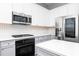 Stainless steel appliances and gray/white cabinetry add style to this modern kitchen with center island at 1292 Creekside Se Ter, Smyrna, GA 30082