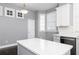 Bright kitchen with a large island, white cabinets, stainless steel appliances, and elegant lighting at 1292 Creekside Se Ter, Smyrna, GA 30082