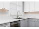 Close-up of the kitchen sink and backsplash, showcasing stainless steel appliances and neutral color palette at 1292 Creekside Se Ter, Smyrna, GA 30082
