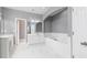 Well lit main bathroom showcasing double vanity, bathtub, and white marble-esque tile floor at 1292 Creekside Se Ter, Smyrna, GA 30082