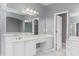 Large main bathroom featuring a double vanity, large mirror, and doorway to a walk-in closet at 1292 Creekside Se Ter, Smyrna, GA 30082
