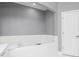 Bright bathtub with a view of the rest of the bathroom, featuring white tile and modern fixtures at 1292 Creekside Se Ter, Smyrna, GA 30082
