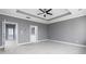 Spacious main bedroom featuring tray ceilings, neutral carpet, and a contemporary ceiling fan at 1292 Creekside Se Ter, Smyrna, GA 30082