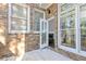Brick patio with glass door and large windows to the interior and views of the backyard trees at 1292 Creekside Se Ter, Smyrna, GA 30082
