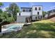 Spacious backyard features a modern pool, lush green lawn, and a sleek modern home at 2110 Fairway Ne Cir, Brookhaven, GA 30319