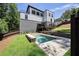 Spacious backyard with a modern pool, lush green lawn, and a sleek modern home at 2110 Fairway Ne Cir, Brookhaven, GA 30319
