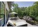 Outdoor balcony with a lounge chair and lovely view of the surrounding trees at 2110 Fairway Ne Cir, Brookhaven, GA 30319