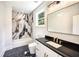 Contemporary bathroom featuring a marble shower, black granite counter tops, and white cabinetry with gold hardware at 2110 Fairway Ne Cir, Brookhaven, GA 30319