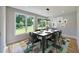 Dining room with modern lighting, room for six, and view of the green outdoors at 2110 Fairway Ne Cir, Brookhaven, GA 30319