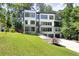 Stunning modern home with a well-manicured lawn and a combination of white siding and gray brick at 2110 Fairway Ne Cir, Brookhaven, GA 30319