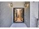 Elegant black framed glass double doors surrounded by gray brick, showcasing a modern entrance at 2110 Fairway Ne Cir, Brookhaven, GA 30319